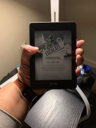 Woman holding a Kindle Paperwhite in her hand